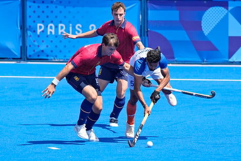 India's Abhishek, right, controls the ball as Spain's Jose Basterra, left, tries to block him during bronze medal match